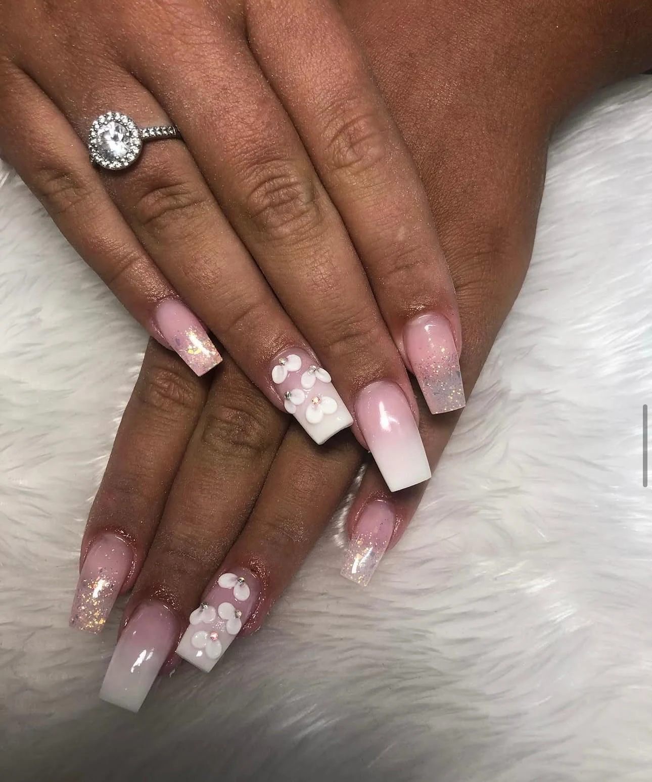 Pink-to-white ombré square acrylic nails with glitter and white 3D flowers by Nailed by Ellie