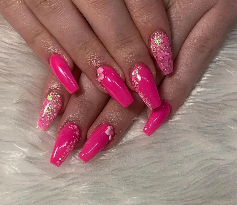 Hot pink coffin acrylic nails with glitter and 3D flowers by Nailed by Ellie